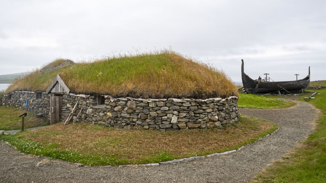 Viking Longhouse reconstruction and the Skidbladner, a full size replica of the Gokstad ship found in a Viking burial mound in Norway in 1880, both located at Haroldswick