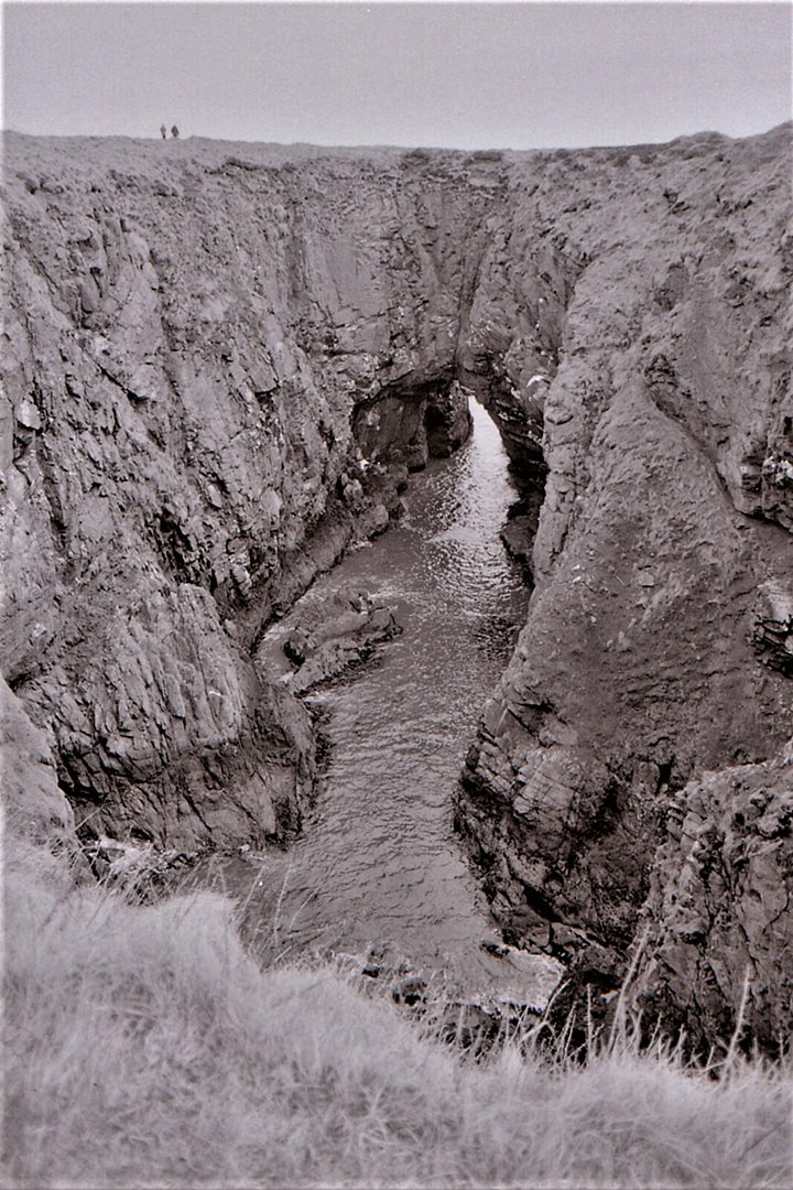 The collapsed sea cave at the Bullers of Buchan photographed in 1979