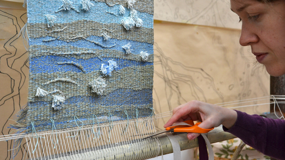 Jo cutting her latest ripple-inspired tapestries off the loom