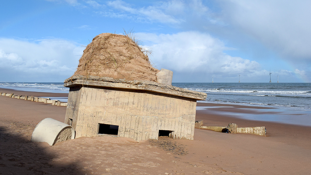 A recently exposed ruined pillbox at Blackdog Beach