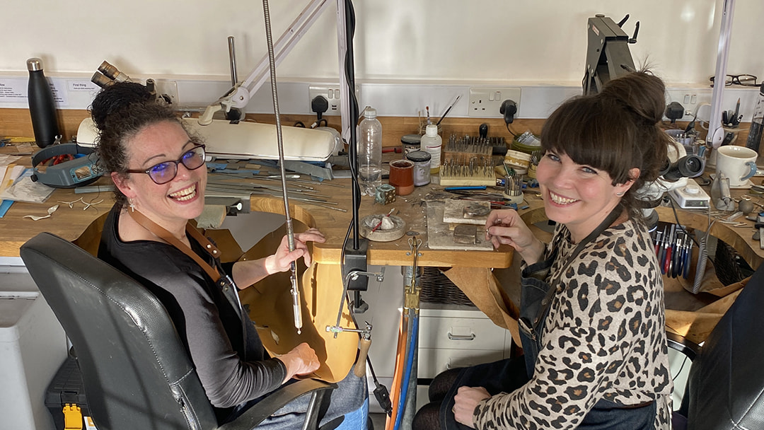 Karlin at a workbench with her sister Marie