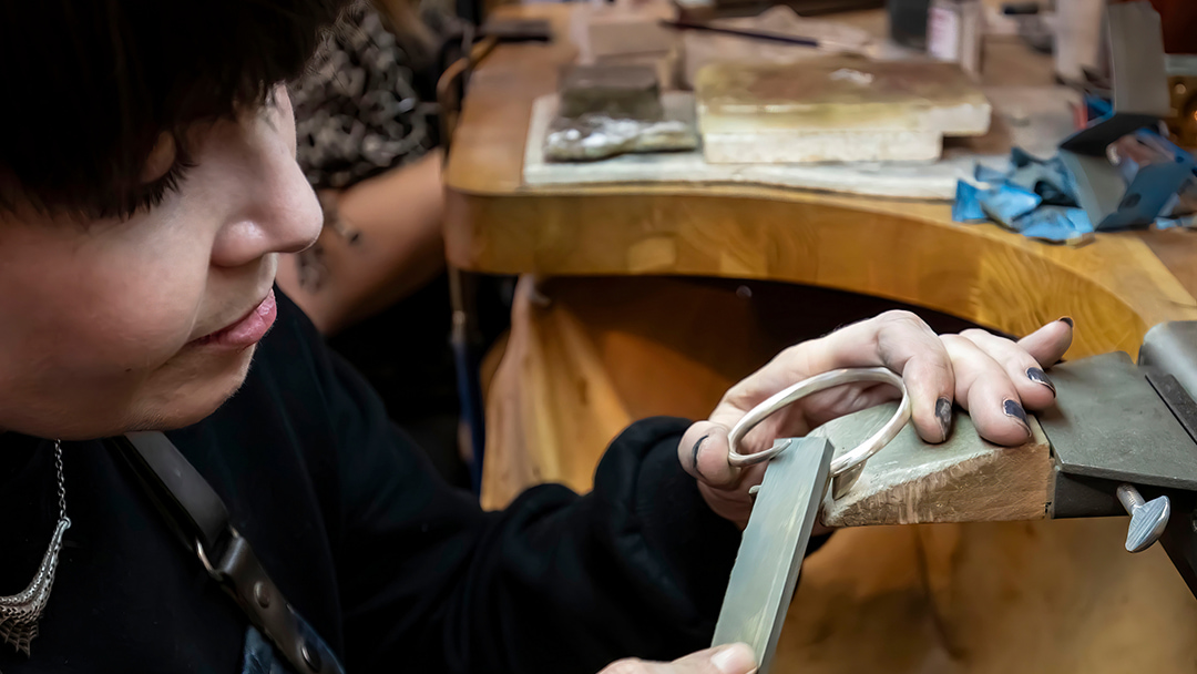 Karlin working on a Wolf Carnassial bangle