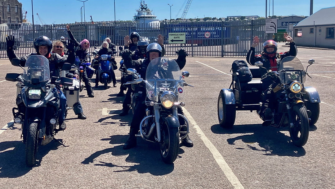 Excited bikers ready to board the ferry in Aberdeen