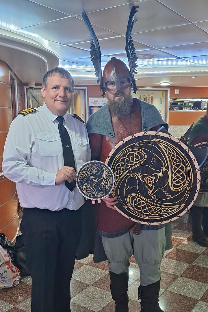 Guizer Jarl JR Umphray presenting Captain McPherson with a shield