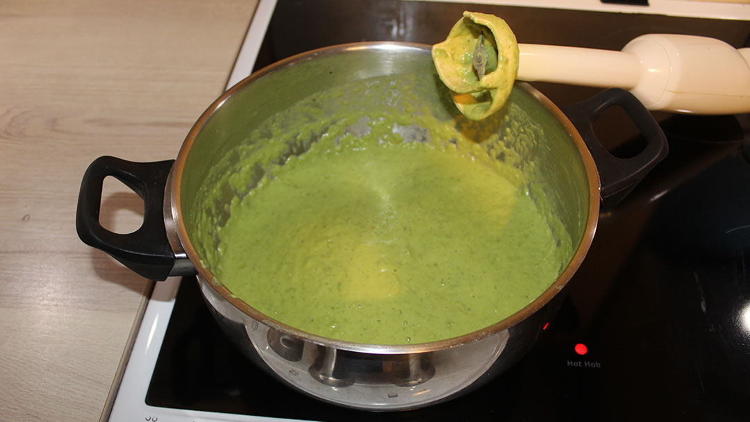 Using a hand blender to liquidise the pea soup