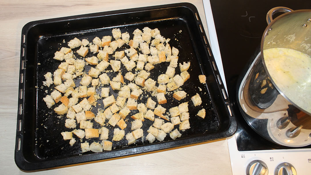 A baking tray with croutons ready for the oven